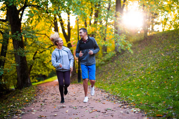 istock Beautiful couple jogging in park. 1049281800
