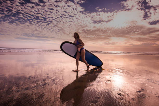 istock Surf girl running in ocean. 1049282166