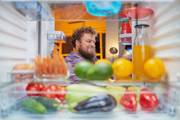 istock Man looking something to eat at night. 1049284588