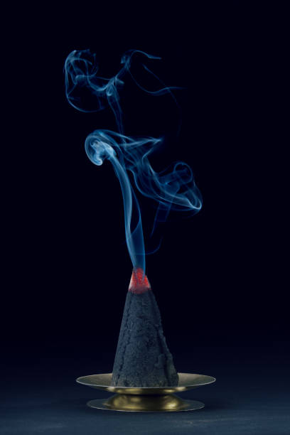 istock Blue smoke moving upper to from burning incense cone shape 1049285250