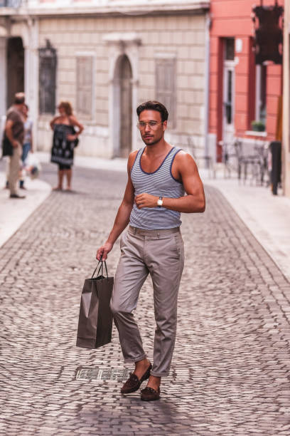 istock Young Man Walking on Italian Street 1049288062