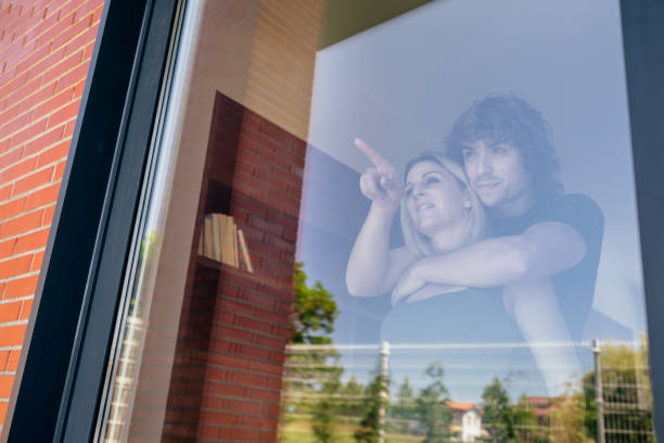 Couple looking at the garden through the window