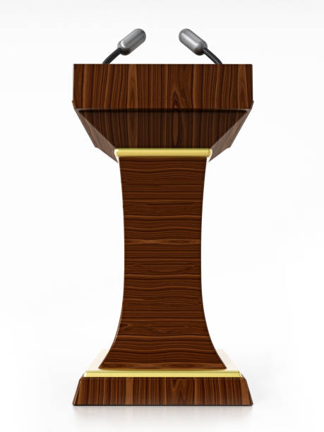 istock Wooden lectern with microphones isolated on white 1049295546