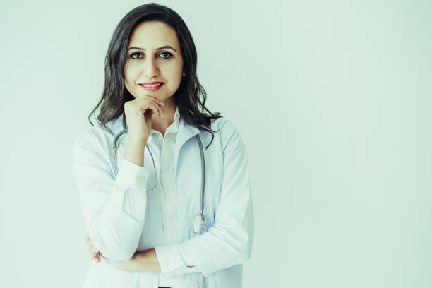 istock Smiling Pretty Female Doctor Touching Chin 1049295766