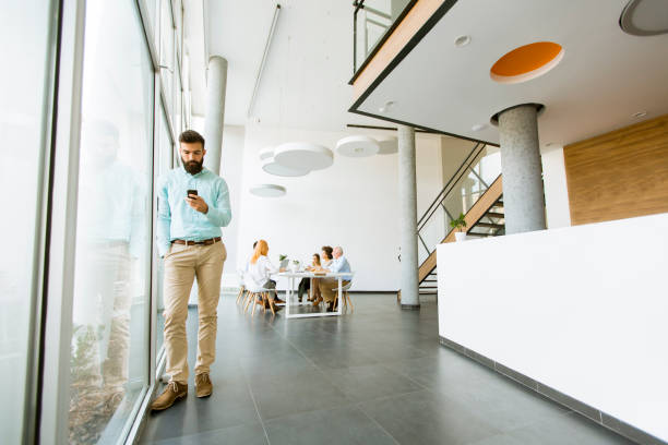istock Young businessman using mobile phone in office 1049298874