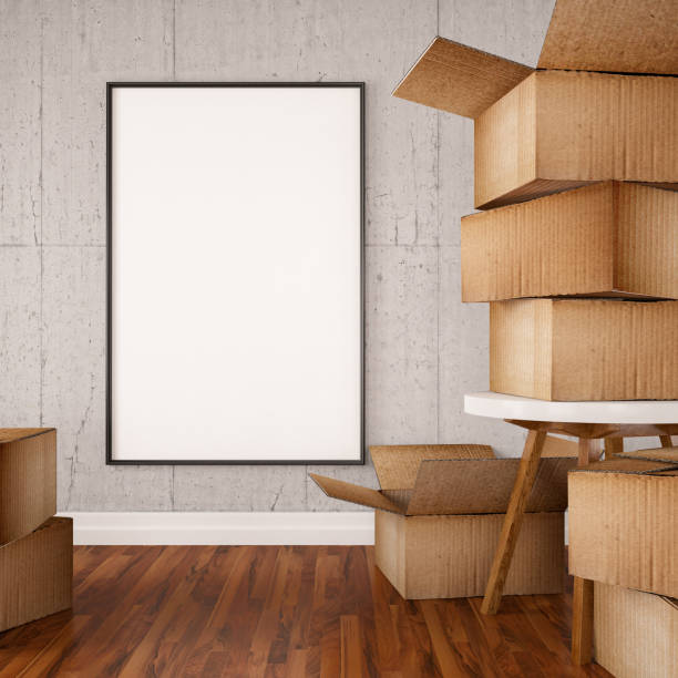 istock Moving into a new house Concept with Carboard Boxes and Empty Frame 1049306098