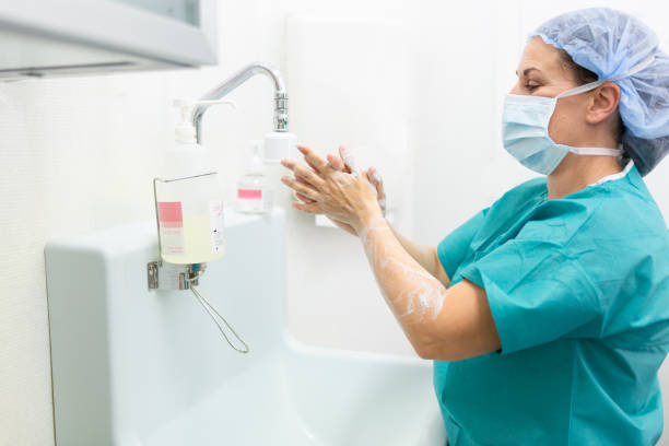 istock Surgeon woman Washing Hands Before Operating 1049306268