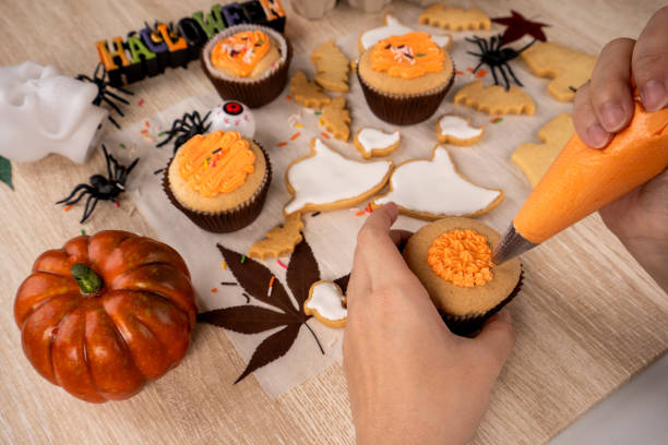 istock Fresh homemade decorating halloween dessert with ghost, creeping spider, bat, haunted castle and horrifying eyeball on wooden background, copy space 1049310964