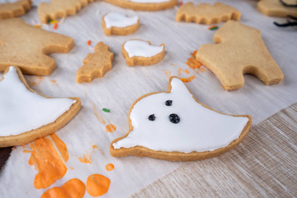 istock Fresh homemade decorating halloween dessert with ghost, creeping spider, bat, haunted castle and horrifying eyeball on wooden background, copy space 1049311036