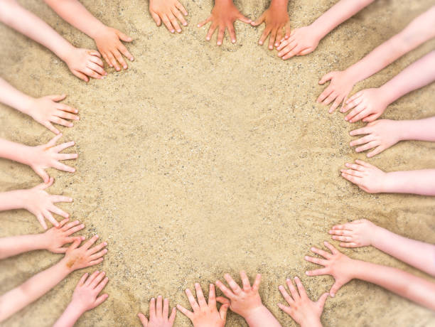 circle of children hands in the sand with copy space as a template - sandbox child human hand sand imagens e fotografias de stock