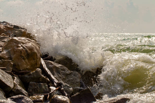 istock Seascape. Splashes break about coastal rocks. 1049314846