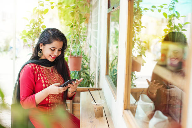 istock Indian girl with phone 1049318294
