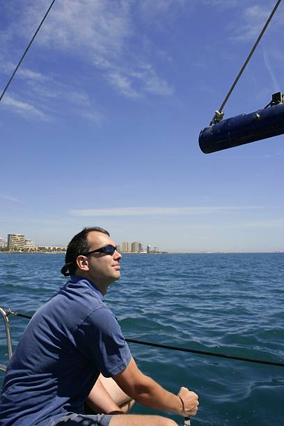 istock Sailor sailing blue tropical sea on sailboat 104932003