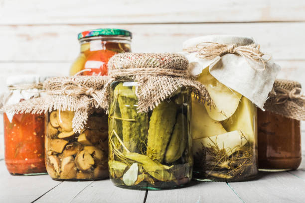 istock Preserved vegetables on wooden background 1049324434