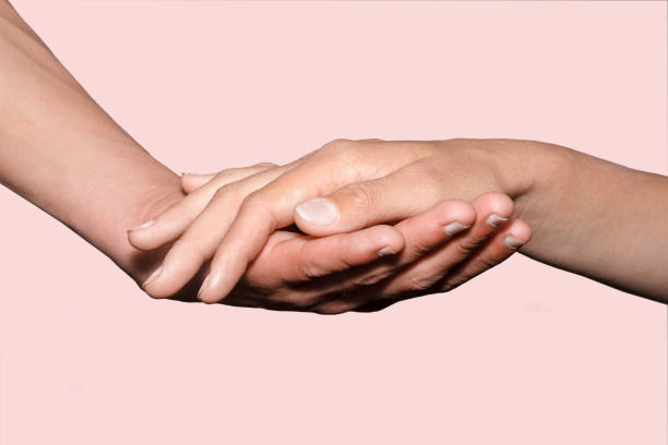 istock female hand holding male hand on background. 1049331922