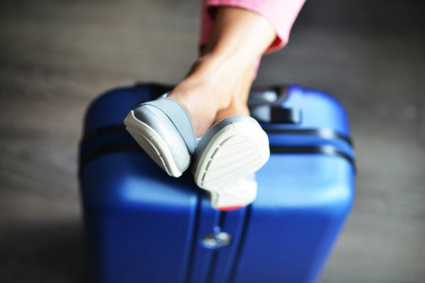 istock Beautiful woman waiting for delayed or connection flight with luggage 1049334742