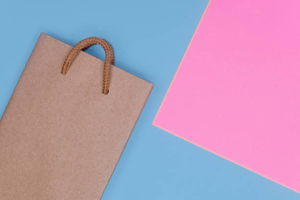 istock Craft paper shopping bag on paper textured backdrop. 1049334862