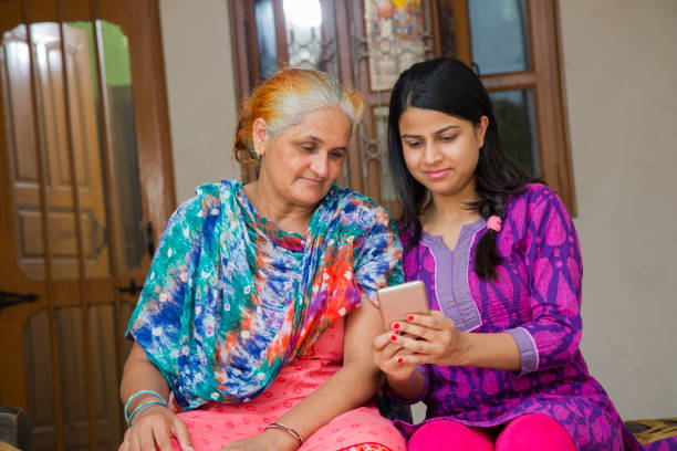 istock Mother daughter using phone - stock images 1049335090