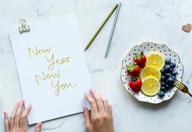 Woman writing New Year New You stock photo