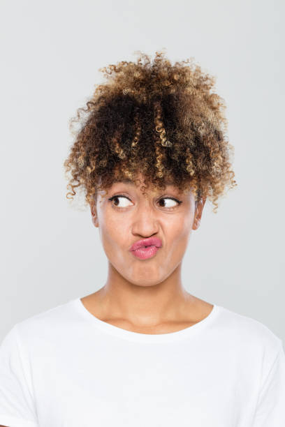 istock Doubtful afro american woman looking away 1049342460