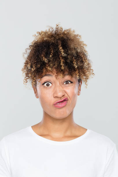 istock Confused young african woman on grey background 1049342798