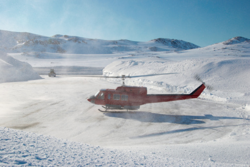 A red helicopter while takeoff, Greenland