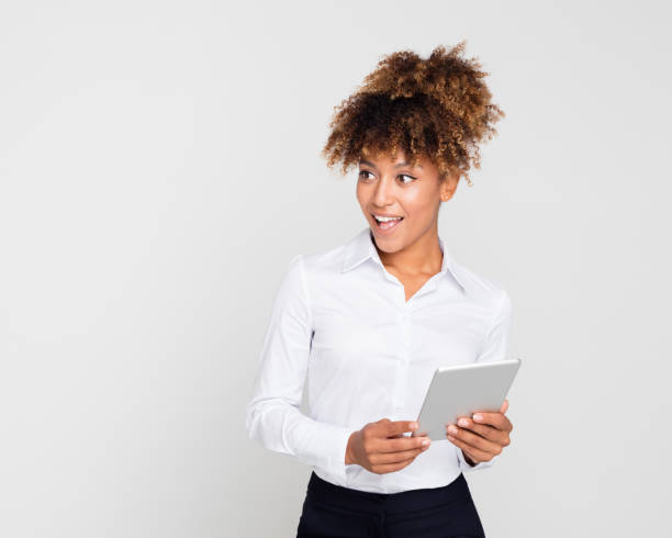 Surprised african businesswoman with a digital tablet