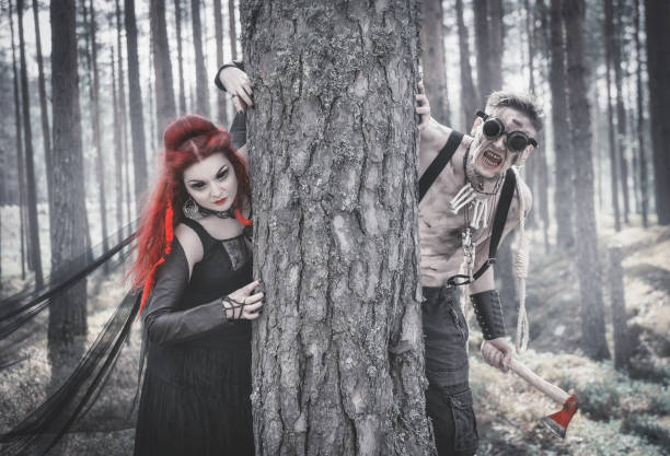terrible steampunk man and beautiful witch in forest - witch voodoo smiling bizarre imagens e fotografias de stock