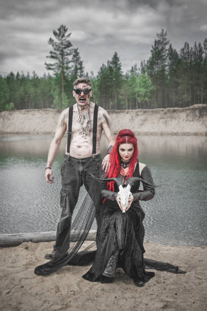 terrible steampunk man and beautiful witch with goat skull - witch voodoo smiling bizarre imagens e fotografias de stock