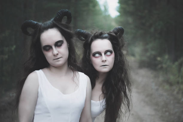 istock Two twins demons with horns in forest 1049347082