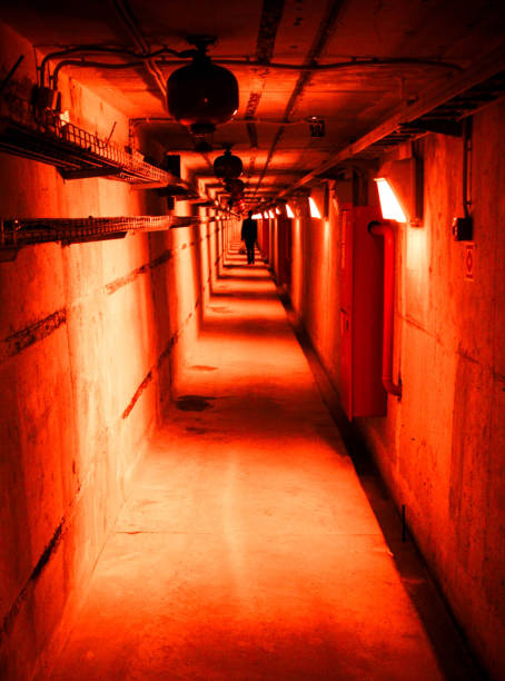 istock Psychedelic red deep in underground tunnel. Industrial background with creepy stranger. 1049350468
