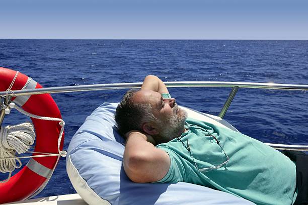 istock Sailor senior man having a rest on summer boat 104935421