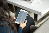 Young woman reading eBook on tablet