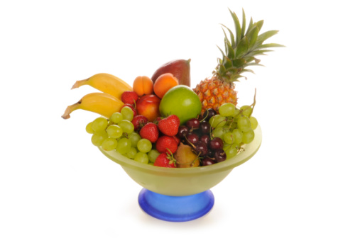Mixed Fruit in glass bowl.Pineapple, banana, nectarine, apricot, cherry, strawberry and mango.studio recording with white background