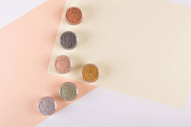 Set of different cosmetic clay mud powders on white background