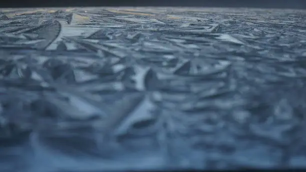 Photo of Close-up Ice Pattern on a Black Car Roof