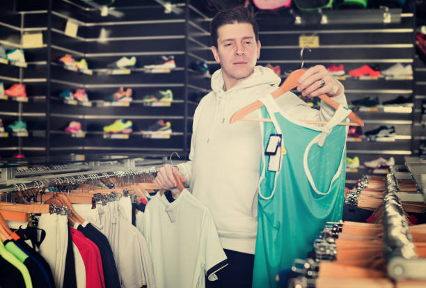 istock Man is looking on modern shirt for sport 1049362028