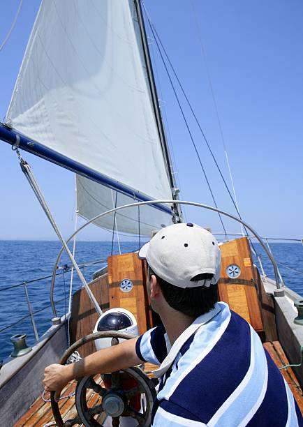 istock Sailor sailing in the sea. Sailboat over blue 104936466