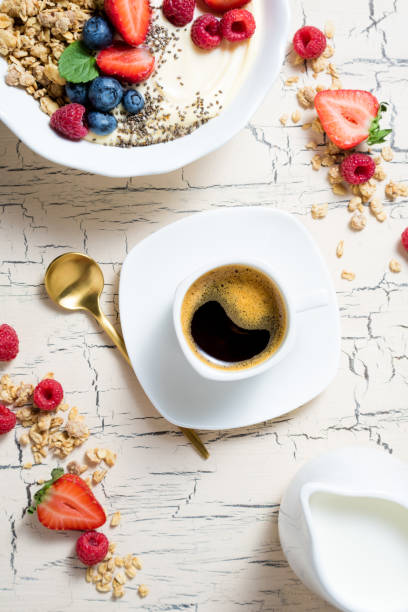 istock Granola with berries, yoghurt and coffee for breakfast. Cereal oats with strawberries, blueberries and raspberries for healthy eating 1049372722