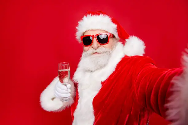 Self-portrait of glad cheerful dreamy Santa congratulations best wishes holding wineglass prepared ready to countdown isolated over bright vivid red background