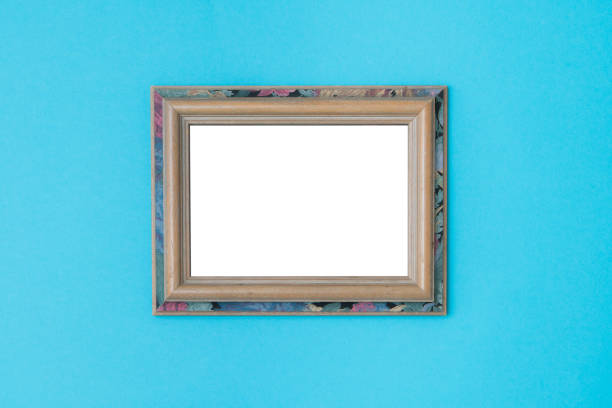 istock Blank empty vintage wooden frames on blue background. 1049376722