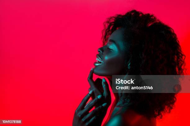 High Fashion Model Woman In Colorful Bright Lights Posing In Studio Stock Photo - Download Image Now