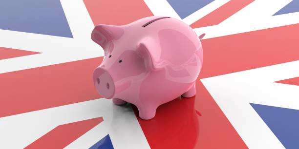 istock 3d rendering pink piggy bank on UK flag 1049385028