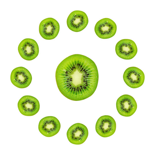 istock Slice of green raw kiwi fruit background, clock composition 1049386582
