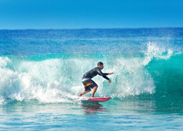 istock Surfer Surfing in Poipu Beach, Kauai,Hawaii 1049389718