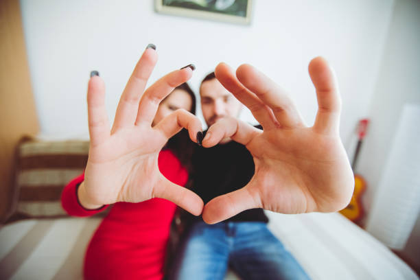 istock Couple showing heart shape with hands 1049394788
