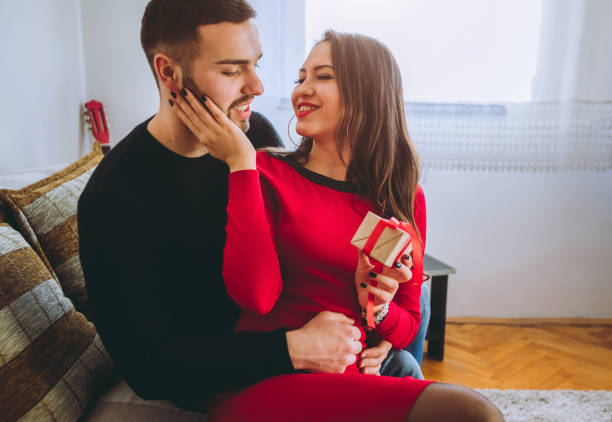 istock Man gives gift to girlfriend 1049397186