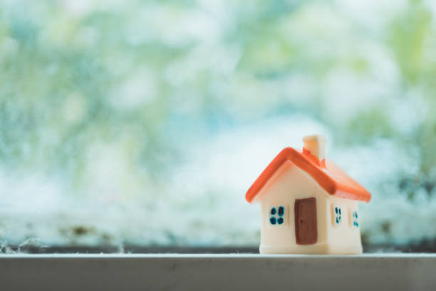 istock Miniature house on nature background 1049399666