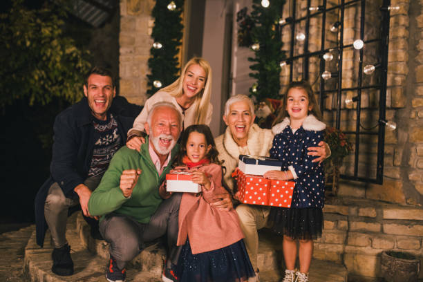istock Smiling family holding Christmas presents 1049400362
