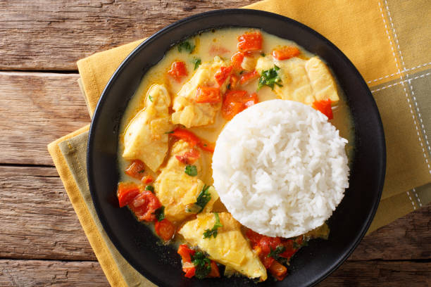 istock Fish stew in coconut milk with vegetables and rice close-up. Horizontal top view 1049403088